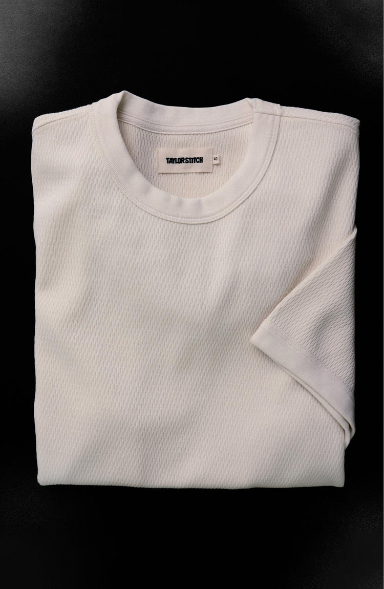 fit model sitting wearing The Organic Cotton Short Sleeve Crew in Vintage White Waffle