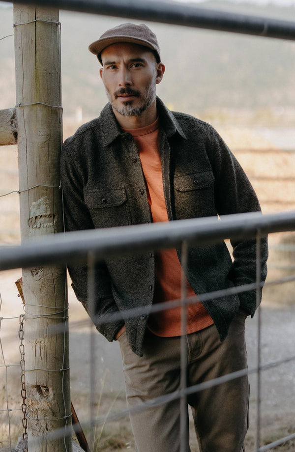 fit model leaning against a pole wearing The Organic Cotton Crew in Summit Orange Waffle