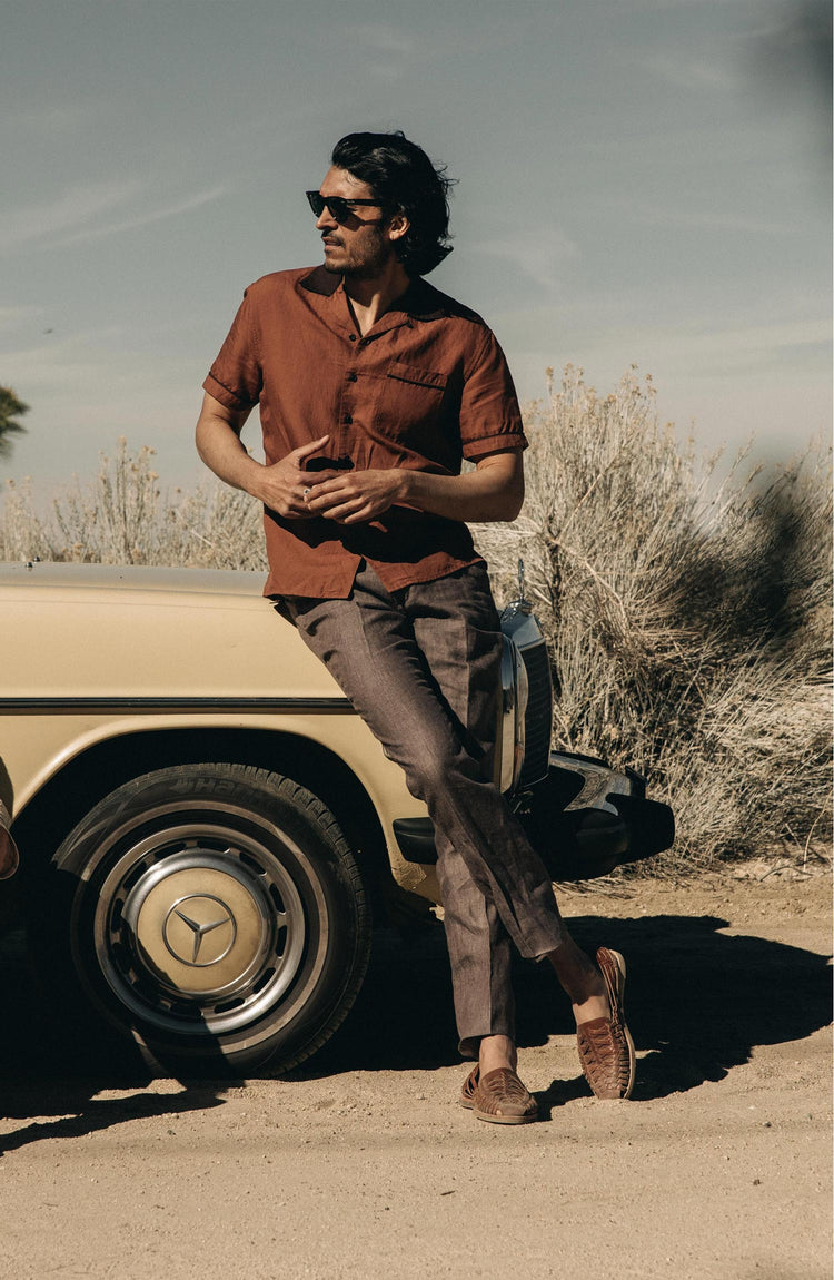 fit model leaning against a car wearing The Palmer Shirt in Dried Guajillo