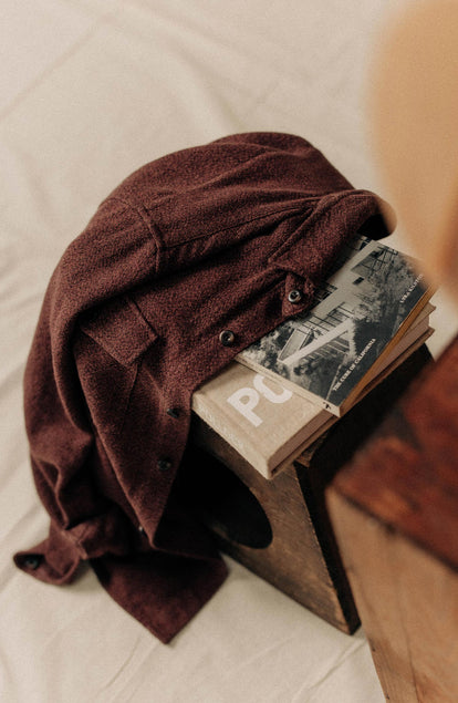 editorial image of The Point Shirt in Burgundy Linen Tweed on books