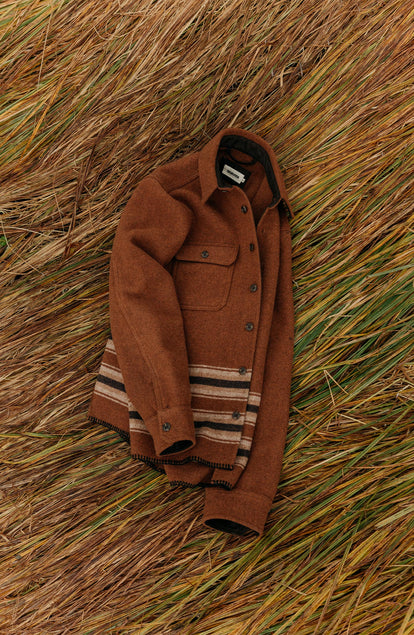 editorial image of The Ranger Shirt in Tarnished Copper Blanket Stripe on grass