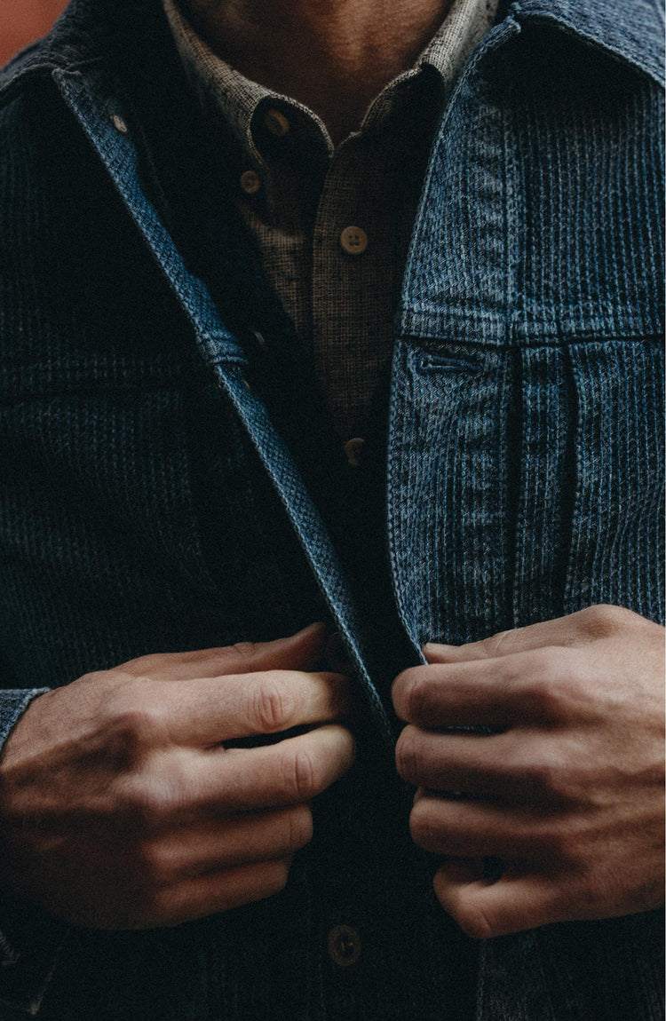 fit model buttoning up The Ryder Jacket in Japanese Washed Indigo Sashiko