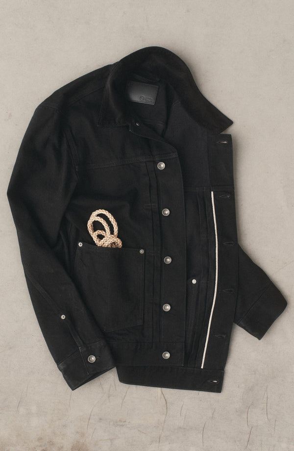 editorial flatlay of The Ryder Jacket in Rinsed Black Organic Selvedge