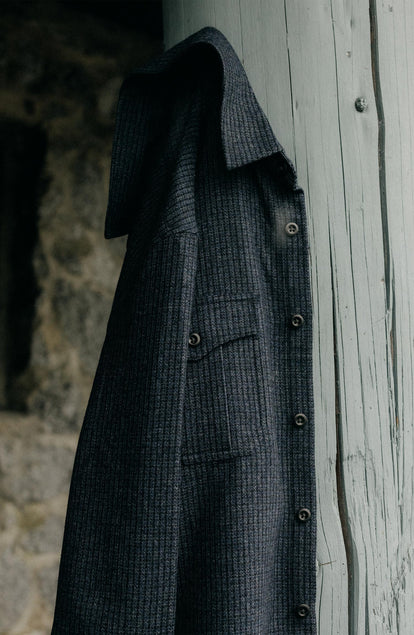 editorial shot of The Saddler Shirt in Midnight Check Wool hanging
