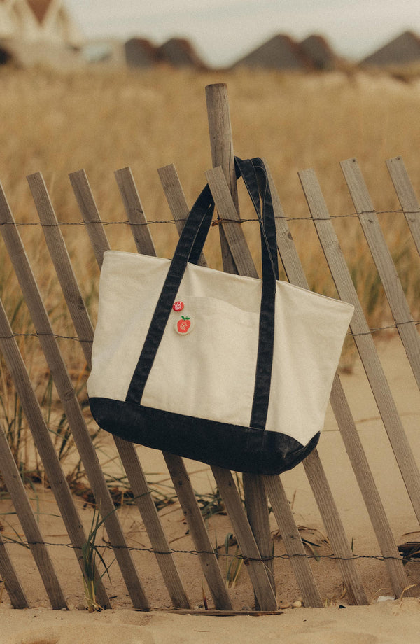 fit model showing off The Topsail Sweater in Dark Navy