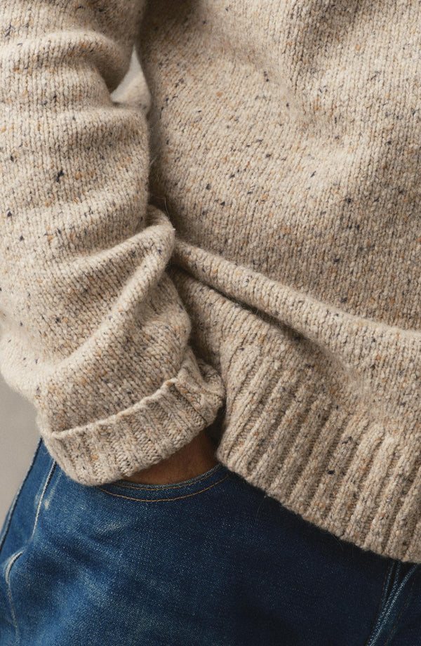 editorial image of The Seafarer Sweater in Natural Donegal on a hanger