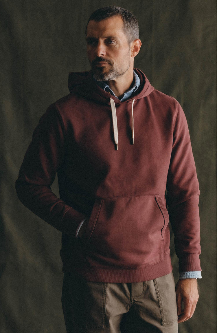 fit model posing in The Shop Hoodie in Dried Cherry