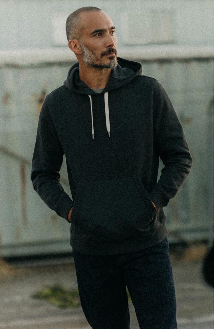 fit model posing in The Shop Hoodie in Faded Black