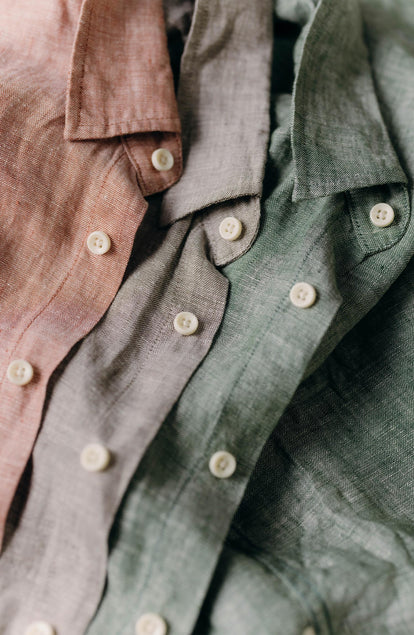editorial flatlay of The Short Sleeve California in Cilantro Hemp next to various shorts