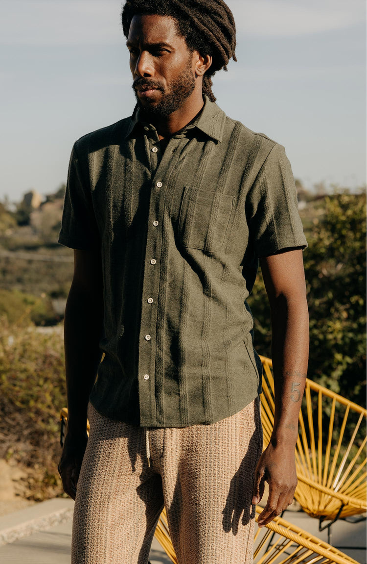fit model posing in The Short Sleeve California in Heather Olive Pointelle Stripe