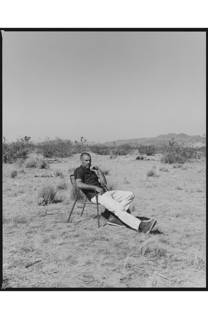 fit model sitting wearing The Short Sleeve Mechanic Shirt in Rinsed Indigo Denim