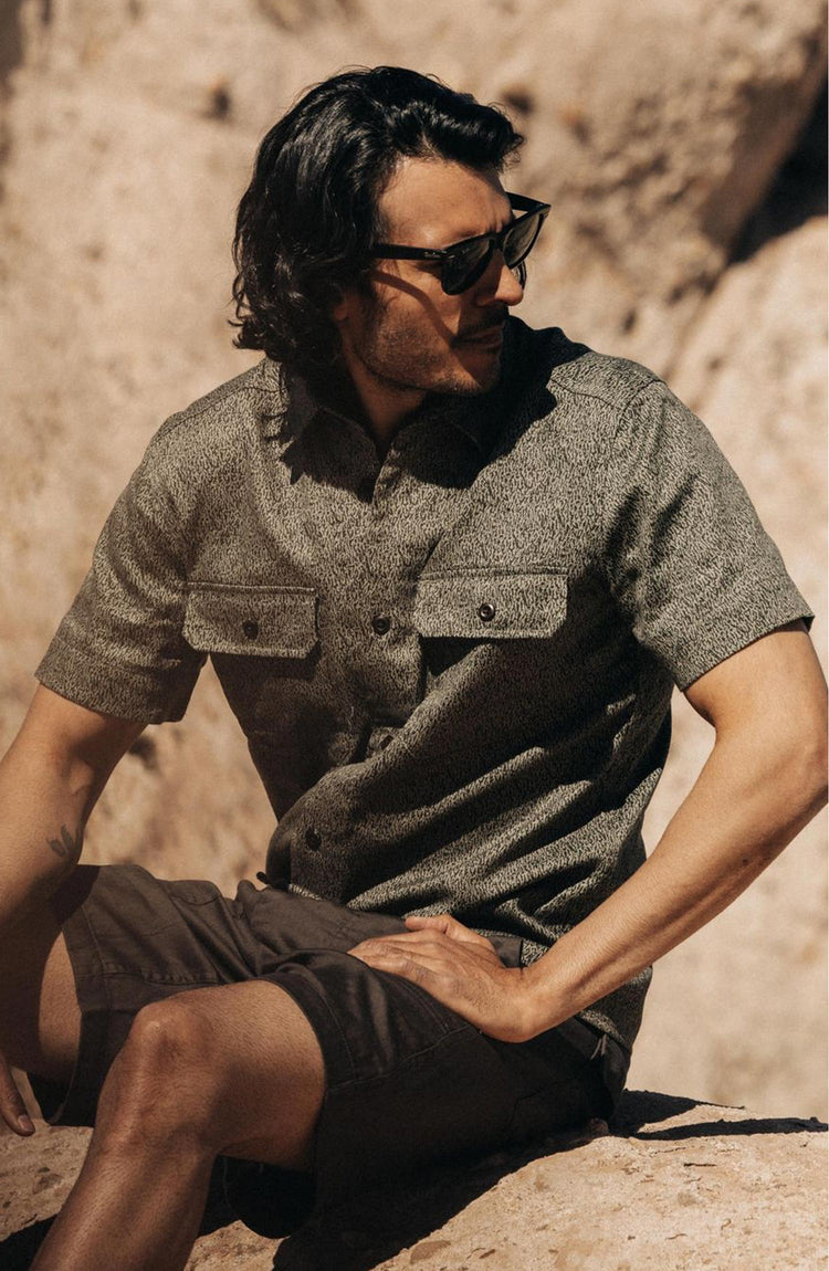 fit model sitting in The Short Sleeve Officer Shirt in Static Camo Double Cloth