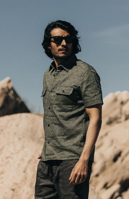 fit model standing in The Short Sleeve Officer Shirt in Static Camo Double Cloth