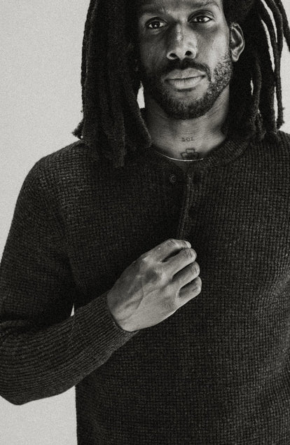 fit model adjusting the buttons on The Sidecountry Sweater in Heather Coal Merino Waffle