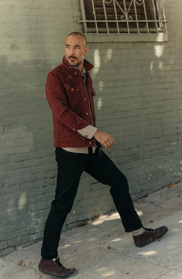 fit model sitting wearing The Slim Jean in Rigid Black Organic Selvedge