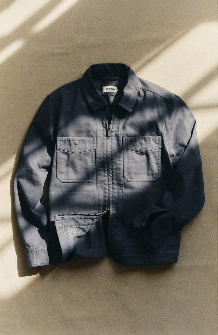 editorial flatlay of the zipper on The Station Jacket in Petrol Blue Broken Twill