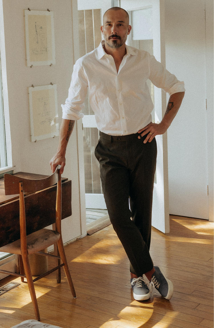 fit model posing in The Stevens Trouser in Black Olive Wool Flannel