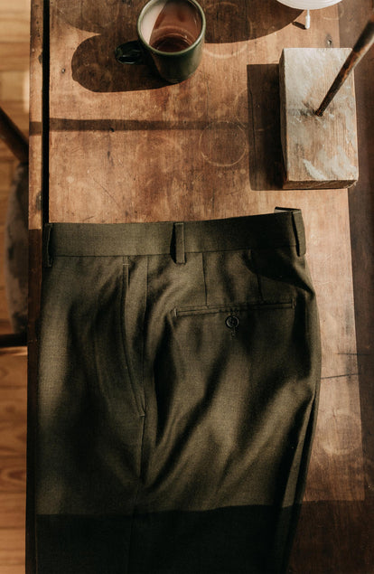 editorial flatlay of The Stevens Trouser in Black Olive Wool Flannel