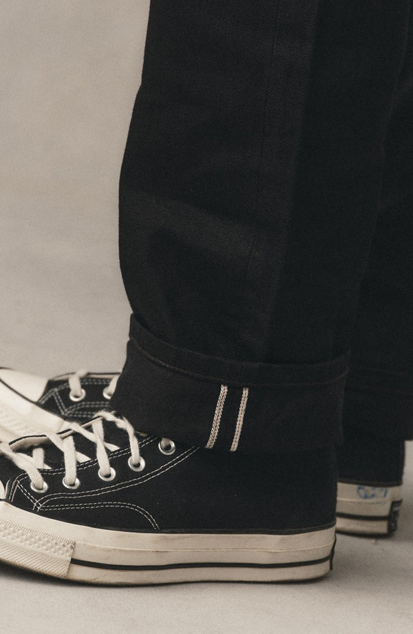fit model showing off the cuff on The Straight Jean in Rinsed Black Organic Selvedge