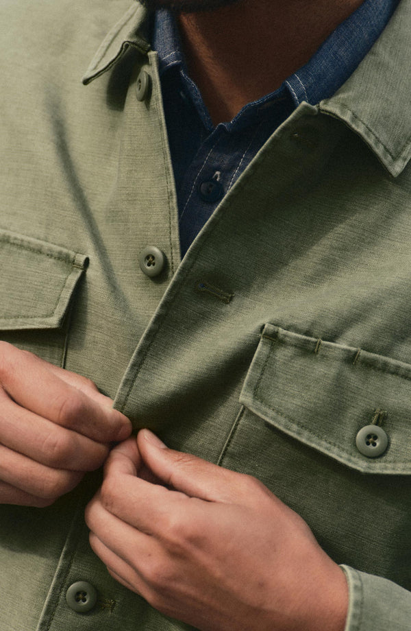 fit model with The Surplus Shirt in Field Olive Reverse Sateen over his shoulder