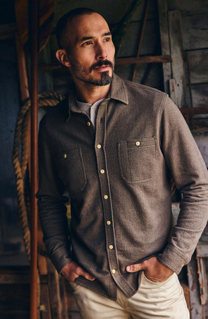 fit model with his hands in his pockets wearing The Utility Shirt in Fatigue Olive French Terry Twill Knit