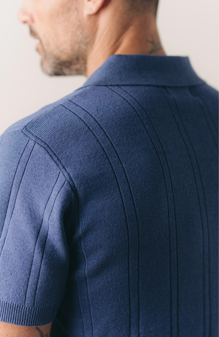 fit model showing off the back of The Valencia Sweater Polo in Heather Clear Blue Rib