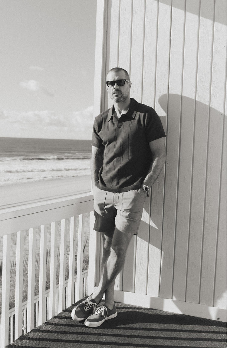 fit model posing in The Valencia Sweater Polo in Heather Coal Rib