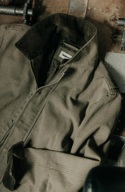 editorial image of The Workhorse Jacket in Stone Chipped Canvas on the ground