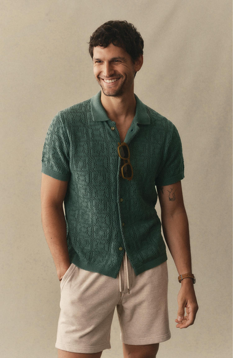 fit model posing in The Monterey Sweater Polo in Deep Sea Geo Crochet
