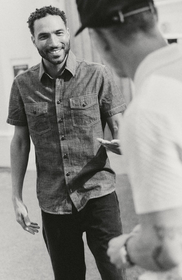 fit model walking wearing The Short Sleeve Crew Shirt in Washed Indigo Chambray