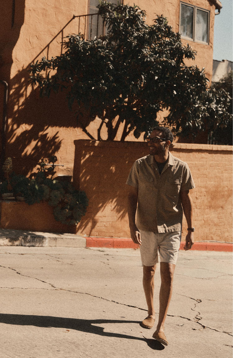 fit model walking in The Apres Short in Organic Aged Stone Foundation Twill