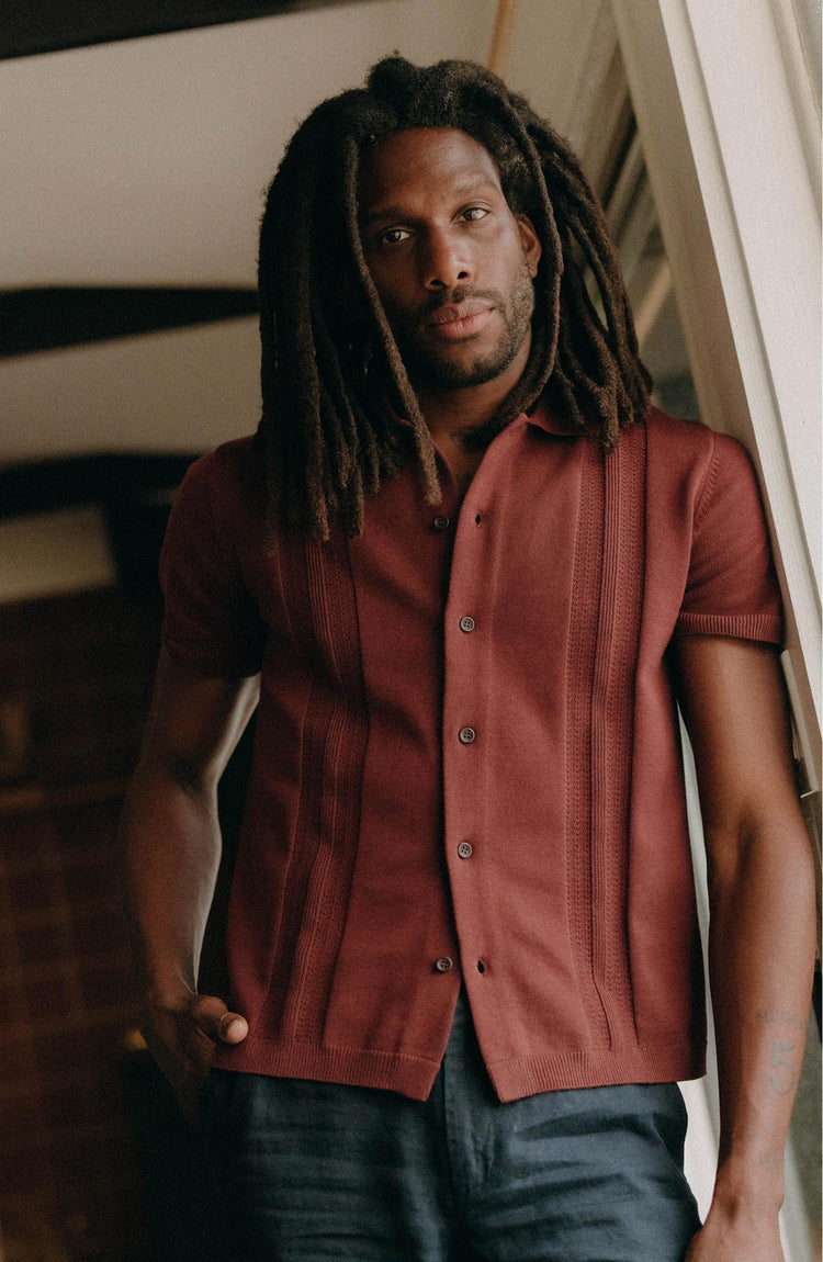 fit model posing in The Button Down Polo in Dried Cherry Stripe