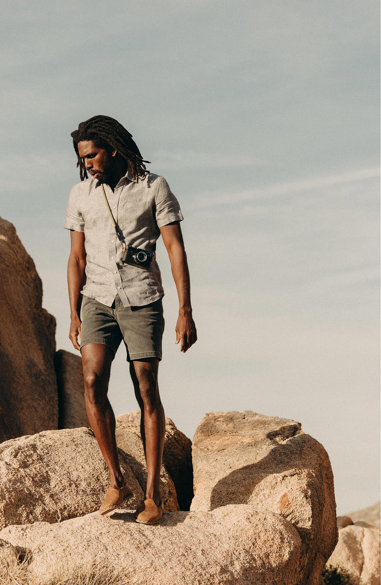 fit model walking on the rocks wearing The Camp Short in Coal Chipped Canvas