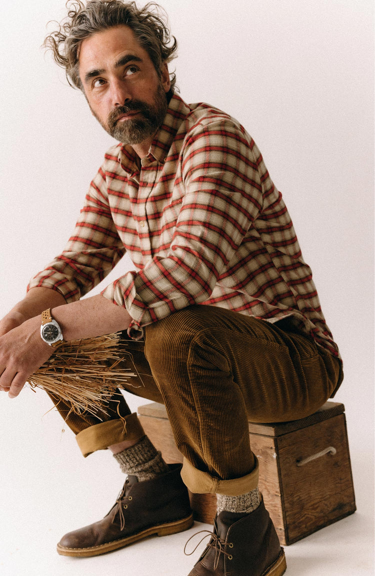 fit model sitting wearing The Carnegie Pant in Bourbon Corduroy