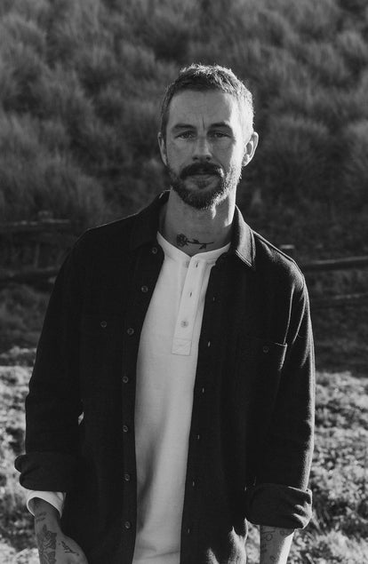 fit model posing in The Coastline Knit Shirt in Dark Navy