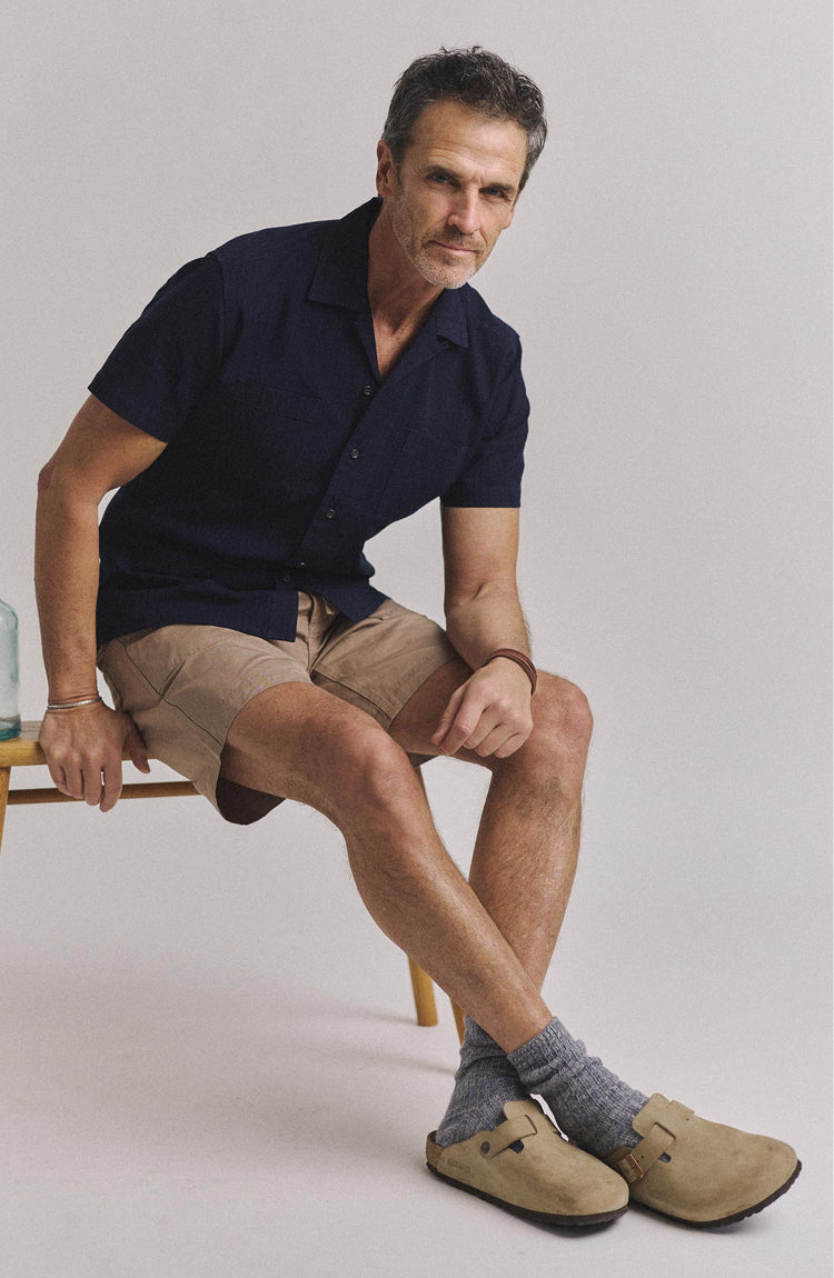 fit model sitting wearing The Conrad Shirt in Rinsed Indigo Pickstitch