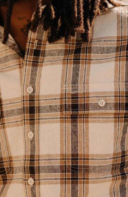 fit model showing off the pocket on The Craftsman Shirt in Bark Plaid Linen