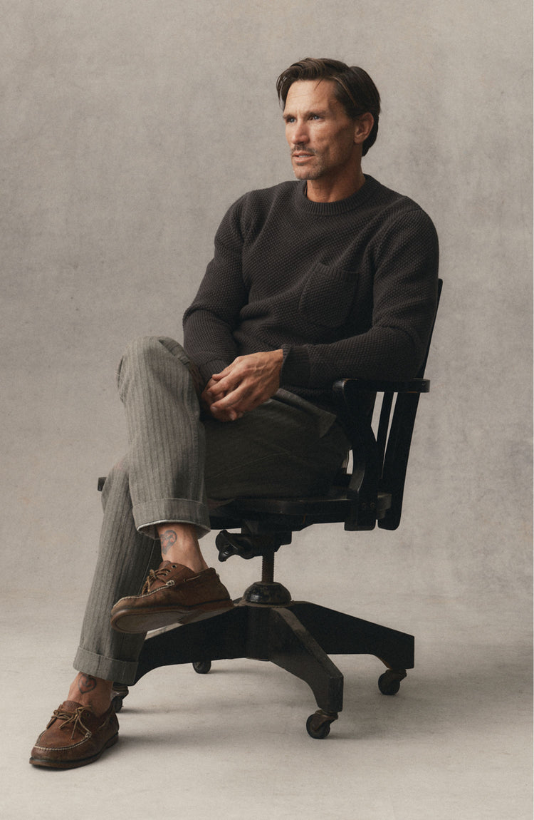 fit model posing in The Crawford Crew Sweater in Charcoal