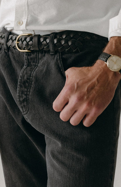 fit model with his hand in his pocket wearing The Democratic Jean in Washed Black Organic Slub Selvedge