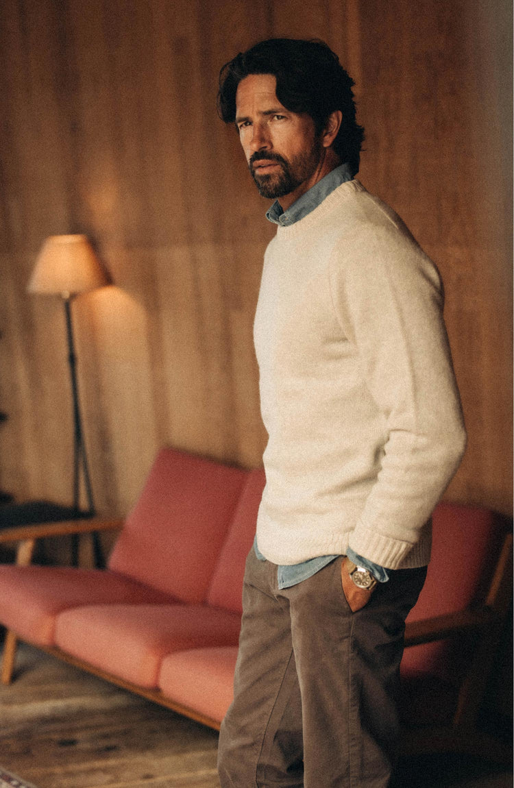 fit model posing in The Eastmoor Sweater in Heather Ivory Wool