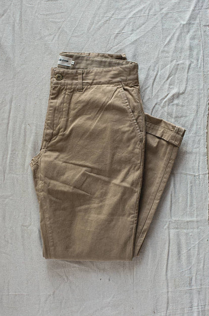A pair of Foundation Pants folded on a black background.