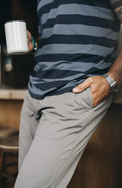 A pair of Foundation Pants folded on a black background, showing the back pocket.