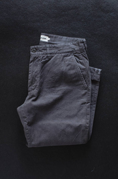 A pair of Foundation Pants folded on a black background.