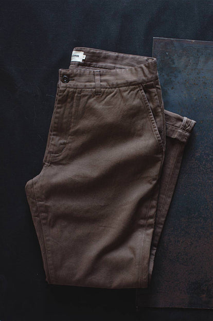 A pair of Foundation Pants folded on a black background.