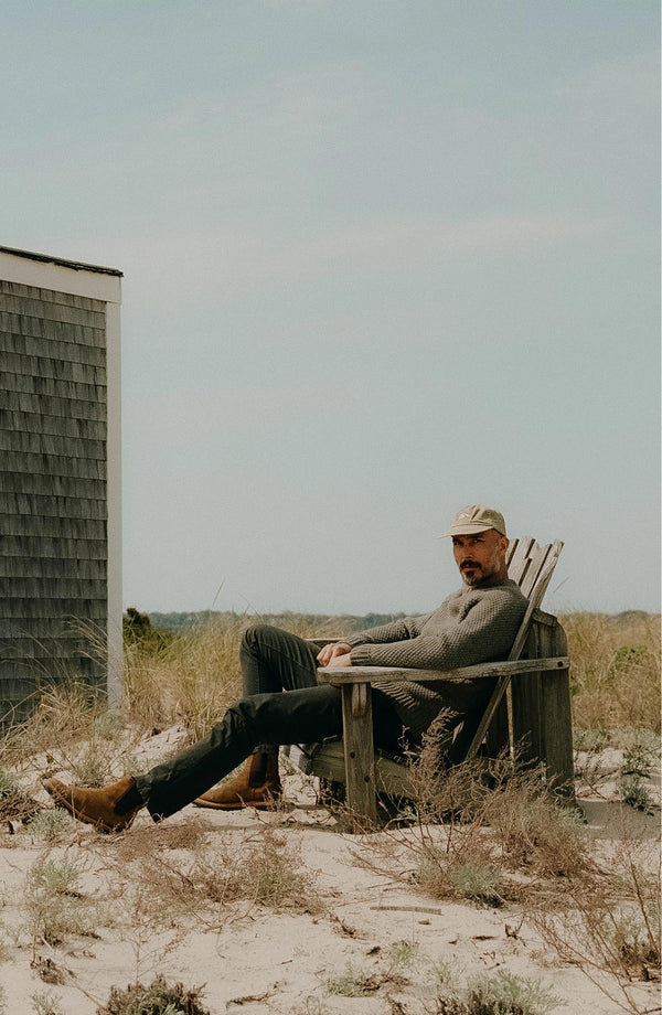 A pair of Foundation Pants folded on a black background.