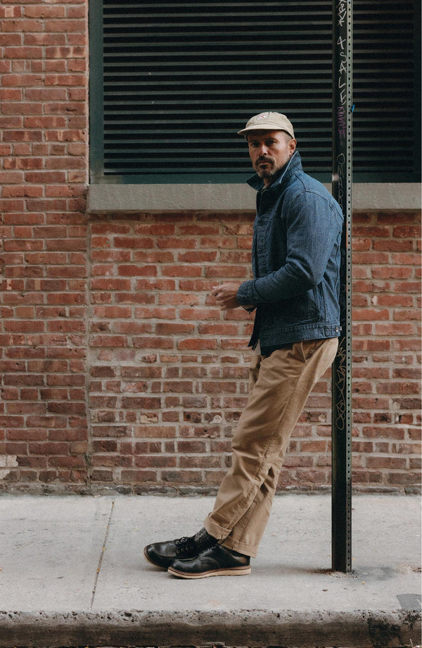 A pair of Foundation Pants folded on a black background.