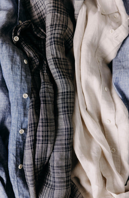 editorial flatlay of The Jack in Navy Plaid Linen next to other linen Jacks