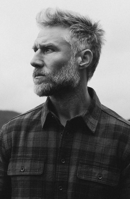 fit model posing in The Ledge Shirt in Heather Granite Plaid