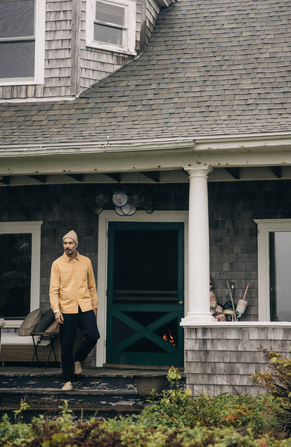 model walking down a front porch in The Lined Utility Shirt in Wheat Denim