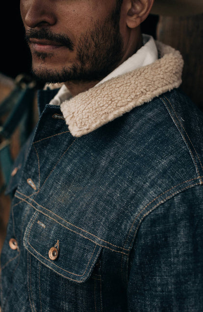 Close up of the model's left shoulder while wearing The Lined Long Haul Jacket in Green Cast Denim